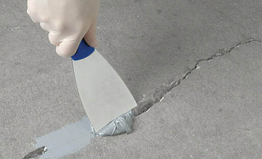 Applying patch material to cracked concrete